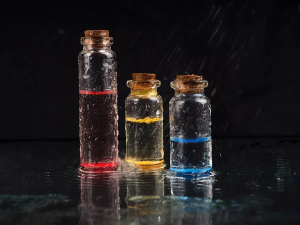 small bottle with samples on a black background.