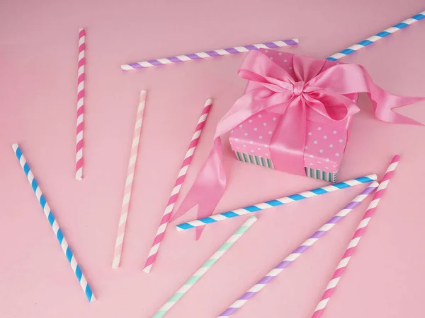 Drinking paper straws for cocktails on pink background. Paper disposable eco-friendly straws.
