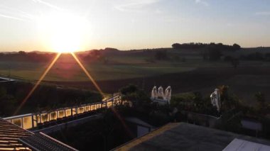 sunset over the fields and houses