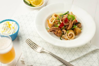 Taze kızarmış Squids, biber ve nane yaprakları beyaz plaka üzerinde