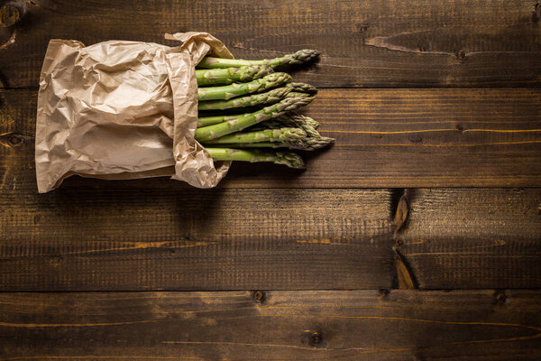 Зеленый спаржа на деревянном фоне с копировальным пространством
