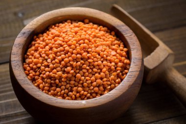 Ahşap masa üzerinde kase kırmızı mercimek