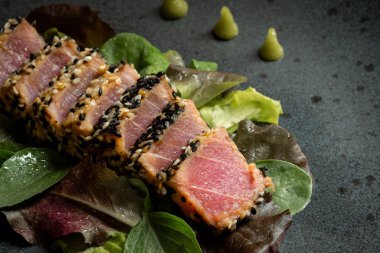 Grilled Sliced Tuna Steak in Sesame with Salad and Wasabi Sauce clipart