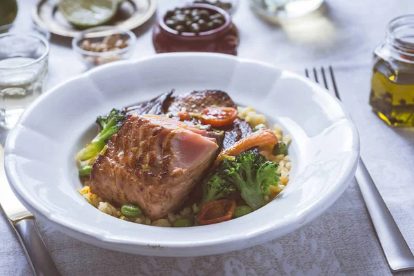 Rustik beyaz tabakta sebze ile somon fileto