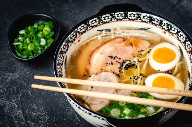 Udon Erişte, Domuz, Yumurta ve Soğan koyu Taş Arka Plan ile Japon Ramen Çorbası