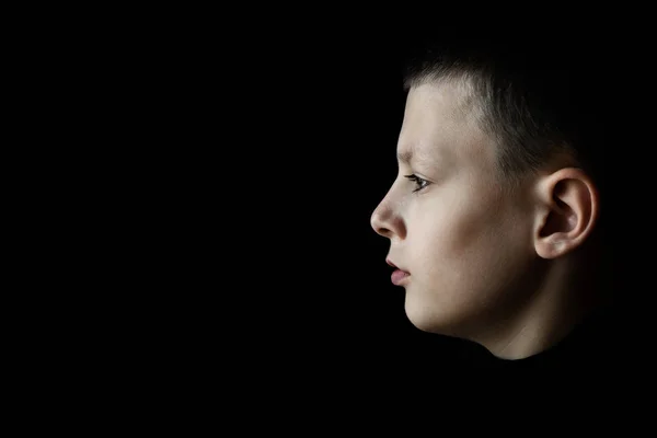 Depressed Sad Boy Profile Portrait on Black Background