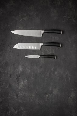 Set of Kitchen Knives on Stone Background clipart
