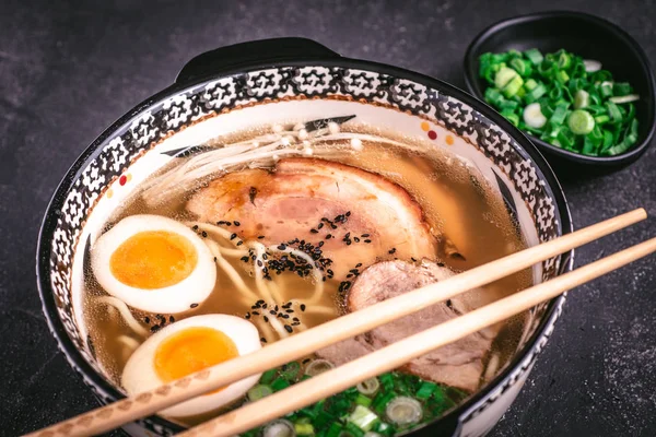 stock image Udon Noodles in Japanese Ramen Soup with Pork, Eggs and Scallion on Dark Background