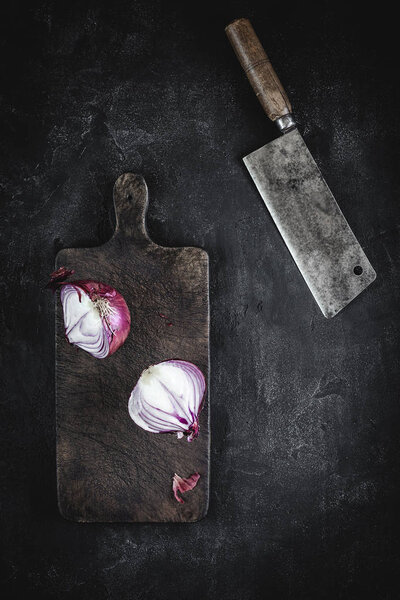 Halved Red Onion on Vintage Cutting Board with Meat Cleaver