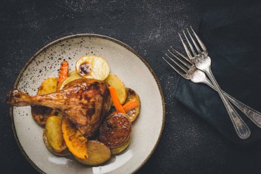 Roasted Goose Leg with Potatoes, Carrots and Oranges clipart