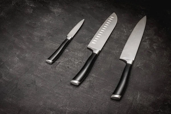 Modern Kitchen Knives Set on Stone Background. Chef\'s Knives Concept.