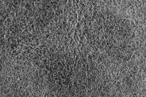 Koyu, desenli, pürüzlü bir kumaş yüzeyinin ayrıntılı ve tek renkli bir görüntüsü..