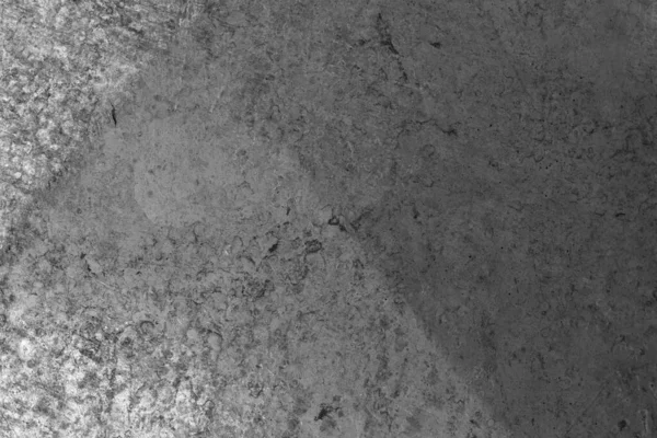 Gri, dokulu bir yüzeyin detaylı ve soyut bir görüntüsü. Işık ve gölgede ince değişimler gösteriyor..