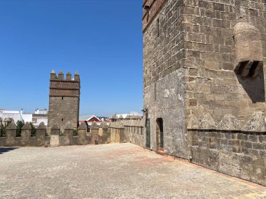 Spain: Historic Castillo de San Marcos in El Puerto de Santa Mara, a 13th-century fortress with Gothic towers and wine cellar, under summer light.