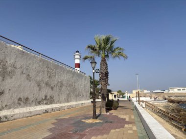 Picturesque historic buildings in the old town of Rota, Spain, featuring whitewashed walls, red-tiled roofs, and narrow cobblestone streets bathed in Andalusian sunlight, blending medieval and modern charm.