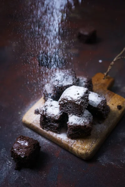 stop motion view: brownie under sugar powder. Low key. Homemade bakery concept. Text space