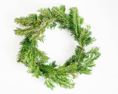 Üst görünüm düz parlak arka planda yeşil Noel çelenk yatıyordu. Geleneksel yeni yıl dekorasyon kavramı. Yazı için alan