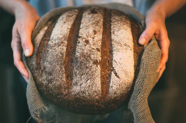 Elinde taze ekmek var.