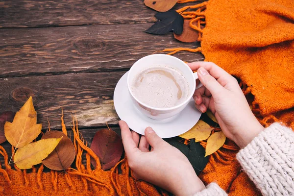 coffee and autumn leaves , hands with plaid