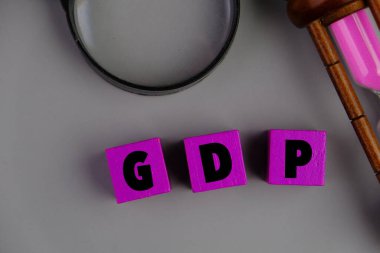 text of GDP on bubble speech. pink background. economics concept