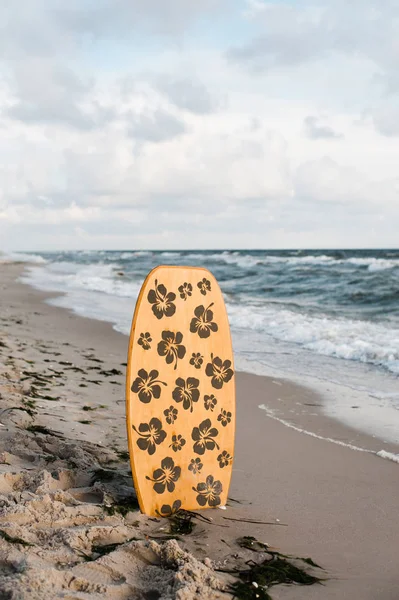 Surfboard in the sand at the beach