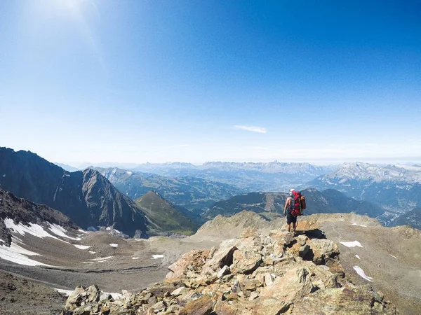 山の頂上に立っているバックパックを持つ旅行者 — ストック写真