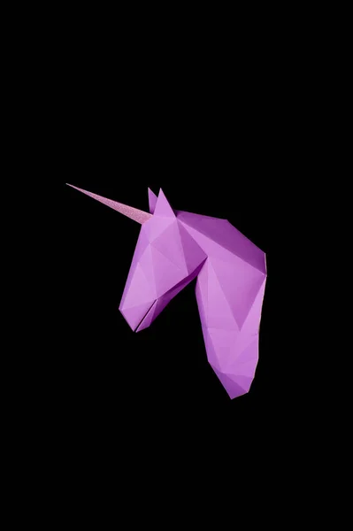 Unicorn violet paper, isolated on a black background. Copy space.