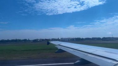 4k footage of an airplane taking off on the runway, take off and embark to the sky, until reaching cruising altitude. Video is seen from airplane window, can see the land below the plane
