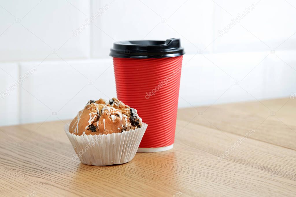 Coffee cardboard glassful with cake in the paper container.