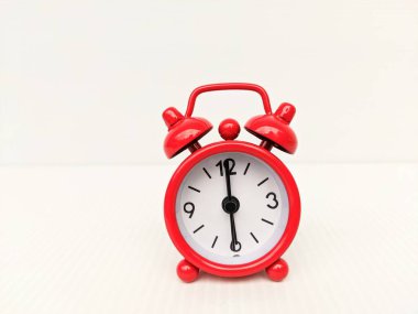 Red alarm clock on white background. Time management and planning concept