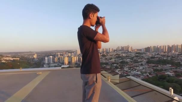 Male Photographer Taking Pictures Top Building Sunset — Stock Video