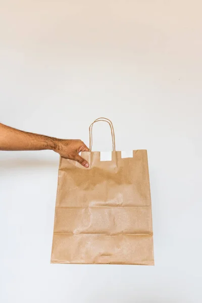 Holding a paper bag isolated. Delivery home food app concept image.