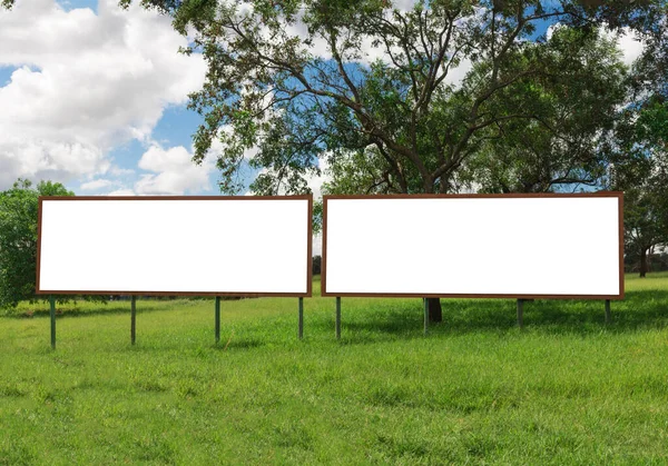 Billboard - Empty billboard in front of beautiful cloudy sky in a rural location. Space for text or design