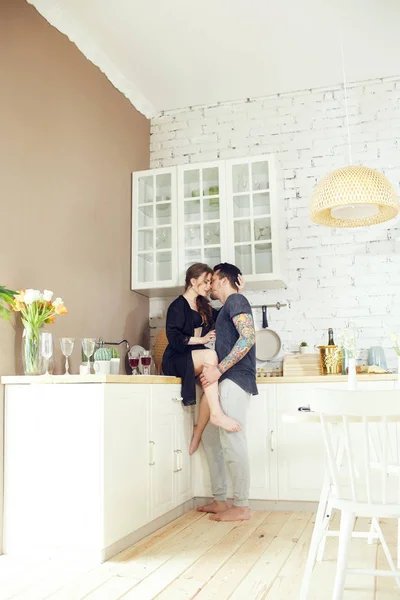 Couple in love has Breakfast in the kitchen early in the morning