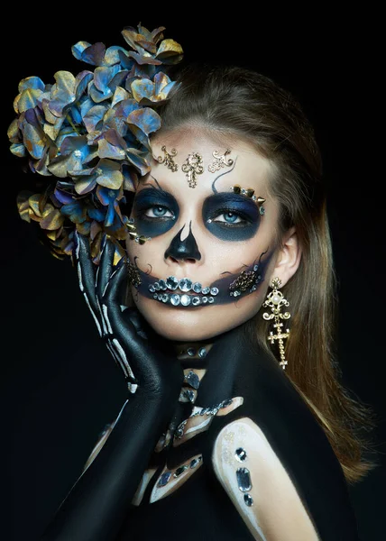 Halloween beauty portrait of a skeleton woman of death, the makeup on the face. Girl death Halloween costume. Day of The Dead. Charming and dangerous Calavera Catrina