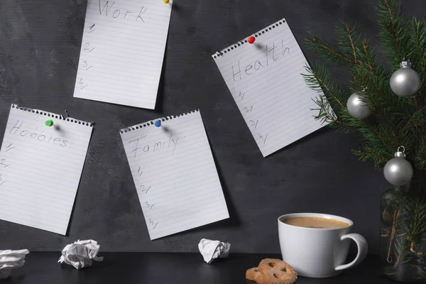 Planning and strategy concept with an office interior with notebook pages pinned to the wall, with lists for work, family, health, and hobbies.