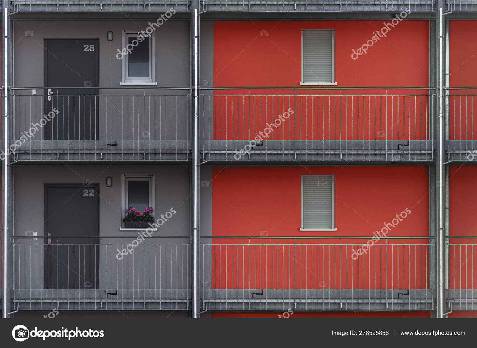 Gray And Red Apartment Building Exterior Close Up Stock Photo