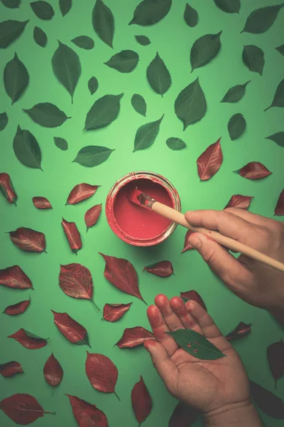 Painting leaves in red with pencil