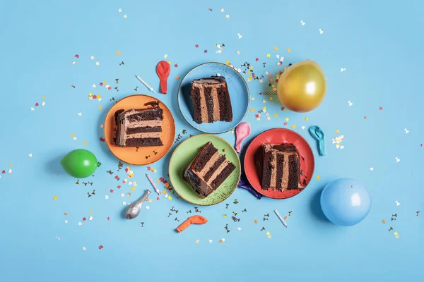 Čokoládové koláče na barevných deskách a dekorace pro party — Stock fotografie
