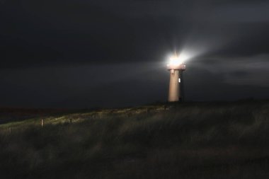 Lighthouse at night on Sylt island, at North sea,  on dunes clipart
