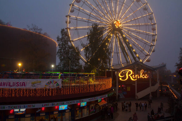 HELSINKI, FINLAND -OCTOBER 12, 2018: The Carnival of Light event at the Linnanmaki amusement park in Helsinki, Finland. Ride Ferris Wheel Rinkeli.