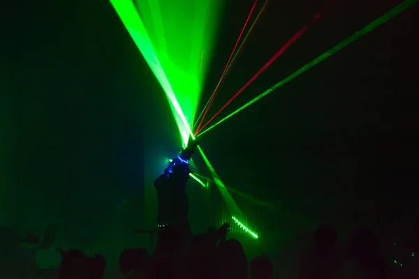 Colorful lights show. Laser show in motion in dark.