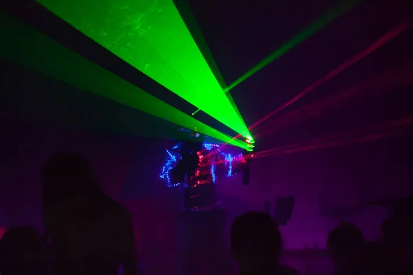 Colorful lights show. Laser show in motion in dark.