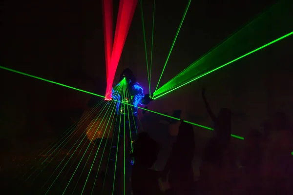 Colorful lights show. Laser show in motion in dark.