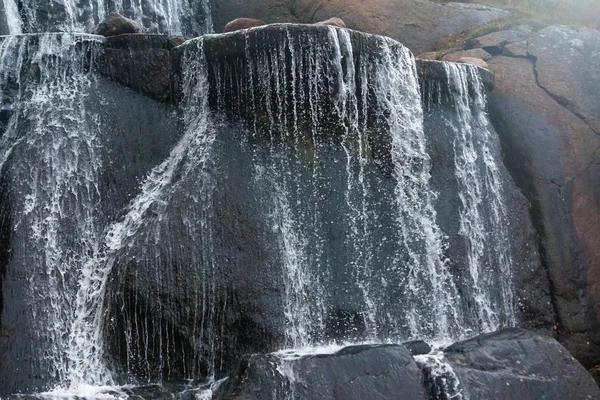 Waterfall cascading over rocks in Sapokka landscaping park Kotka, Finland.