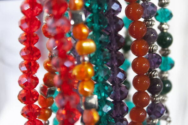Hanging beautiful colorful bead necklaces in store.