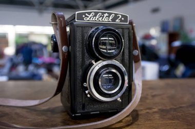 KOUVOLA, FINLAND - NOVEMBER 1, 2018: Vintage twin lens camera Lubitel on the table. clipart