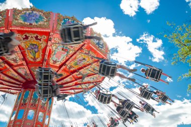 Tampere, Finlandiya-24 Haziran 2019: Ride Swing Carousel mavi gökyüzü arka planda eğlence parkı Sarkanniemi hareket içinde