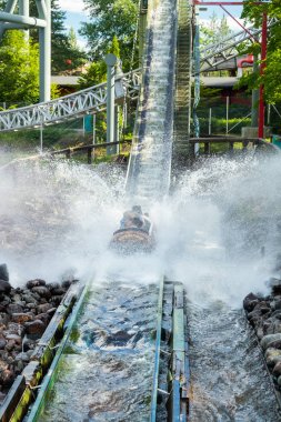 Fun water ride Log river in amusement park at summer clipart