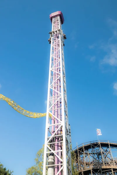 Helsinki, Finland - 14 September 2019: Linnanmaki amusement park, rides tower Raketti in motion and roller coasters Ukko, Vuoristorata — Stock Photo, Image